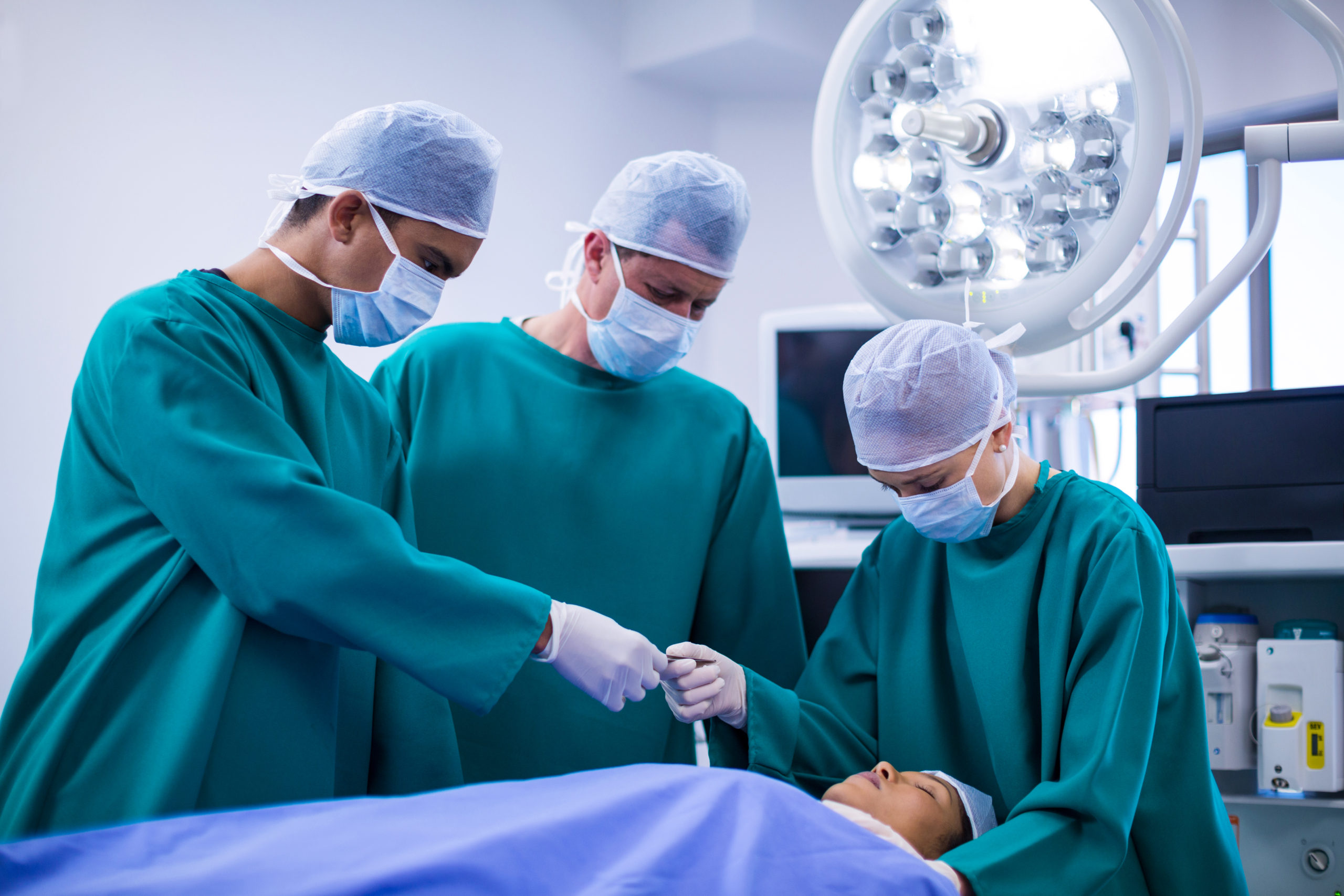 Surgeons performing operation in operation theater of hospital
